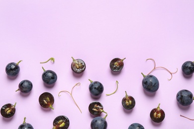 Photo of Flat lay composition with fresh ripe juicy grapes on lilac background, space for text