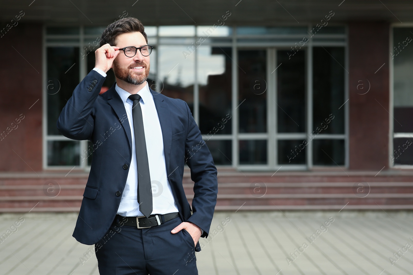 Photo of Handsome real estate agent in nice suit outdoors, space for text