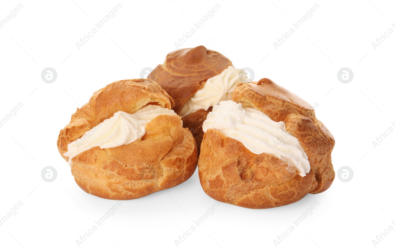 Photo of Delicious profiteroles with cream filling on white background