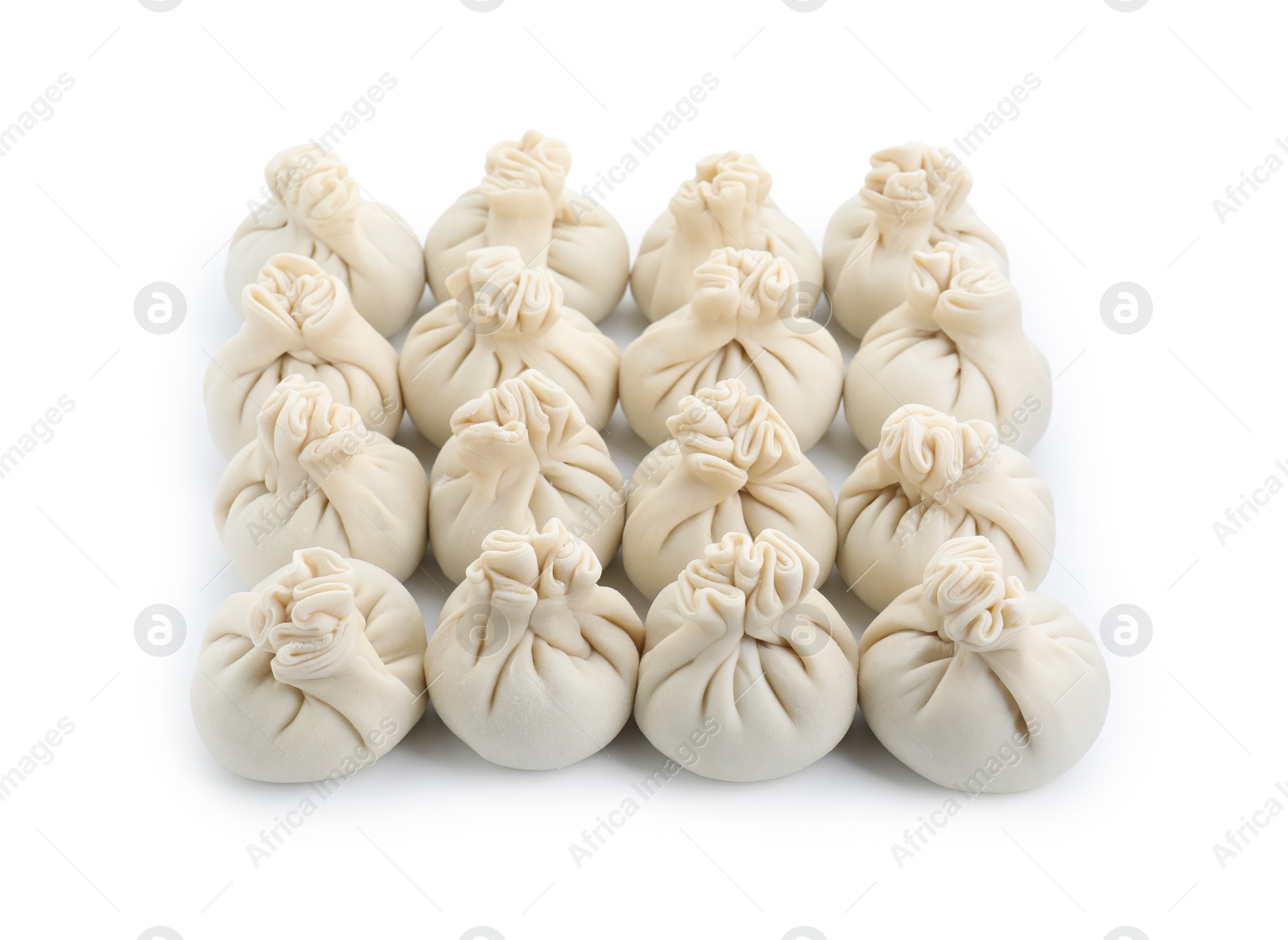 Photo of Uncooked khinkali (dumplings) isolated on white. Georgian cuisine