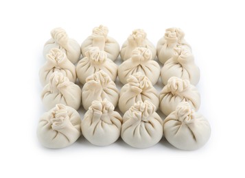 Photo of Uncooked khinkali (dumplings) isolated on white. Georgian cuisine