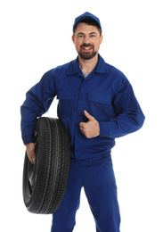 Photo of Portrait of professional auto mechanic with wheel on white background