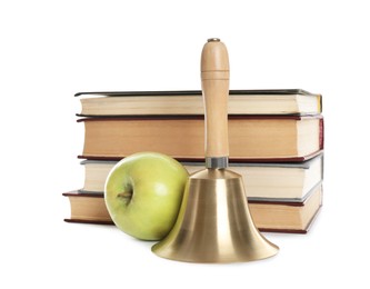 Photo of Golden school bell with wooden handle, apple and stack of books on white background