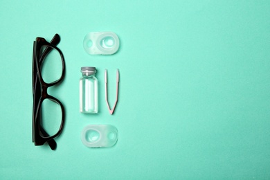 Flat lay composition with glasses, contact lenses and accessories on color background