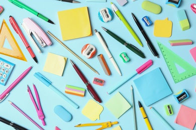 Photo of Flat lay composition with different school stationery on light blue background. Back to school