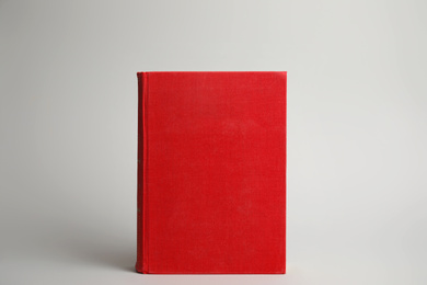 Hardcover book on light grey background. Space for design