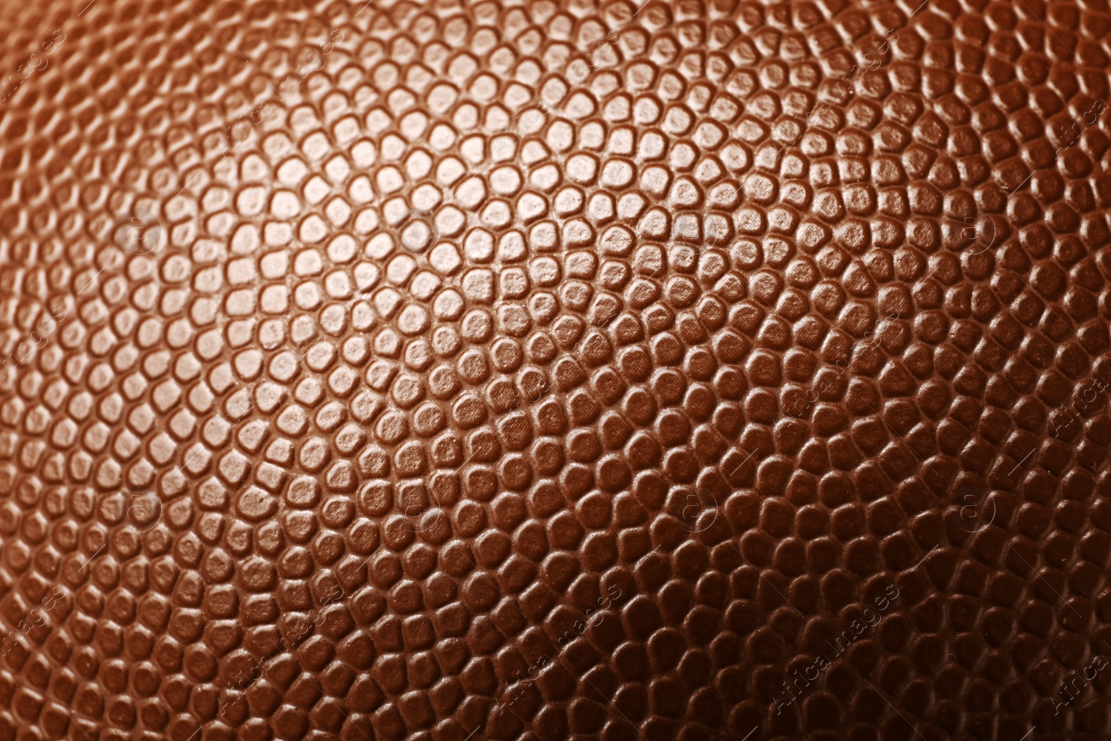 Photo of Leather American football ball as background, closeup