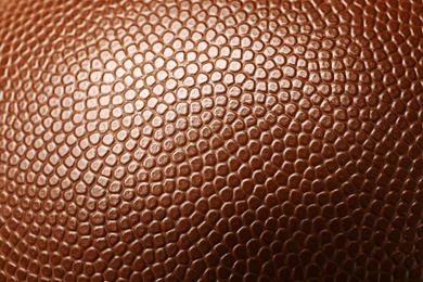 Photo of Leather American football ball as background, closeup