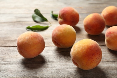 Photo of Fresh sweet peaches on wooden table, closeup