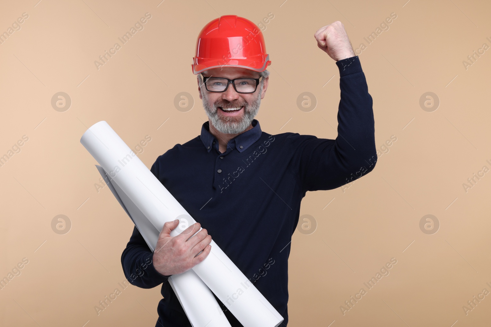 Photo of Architect in hard hat holding drafts on beige background