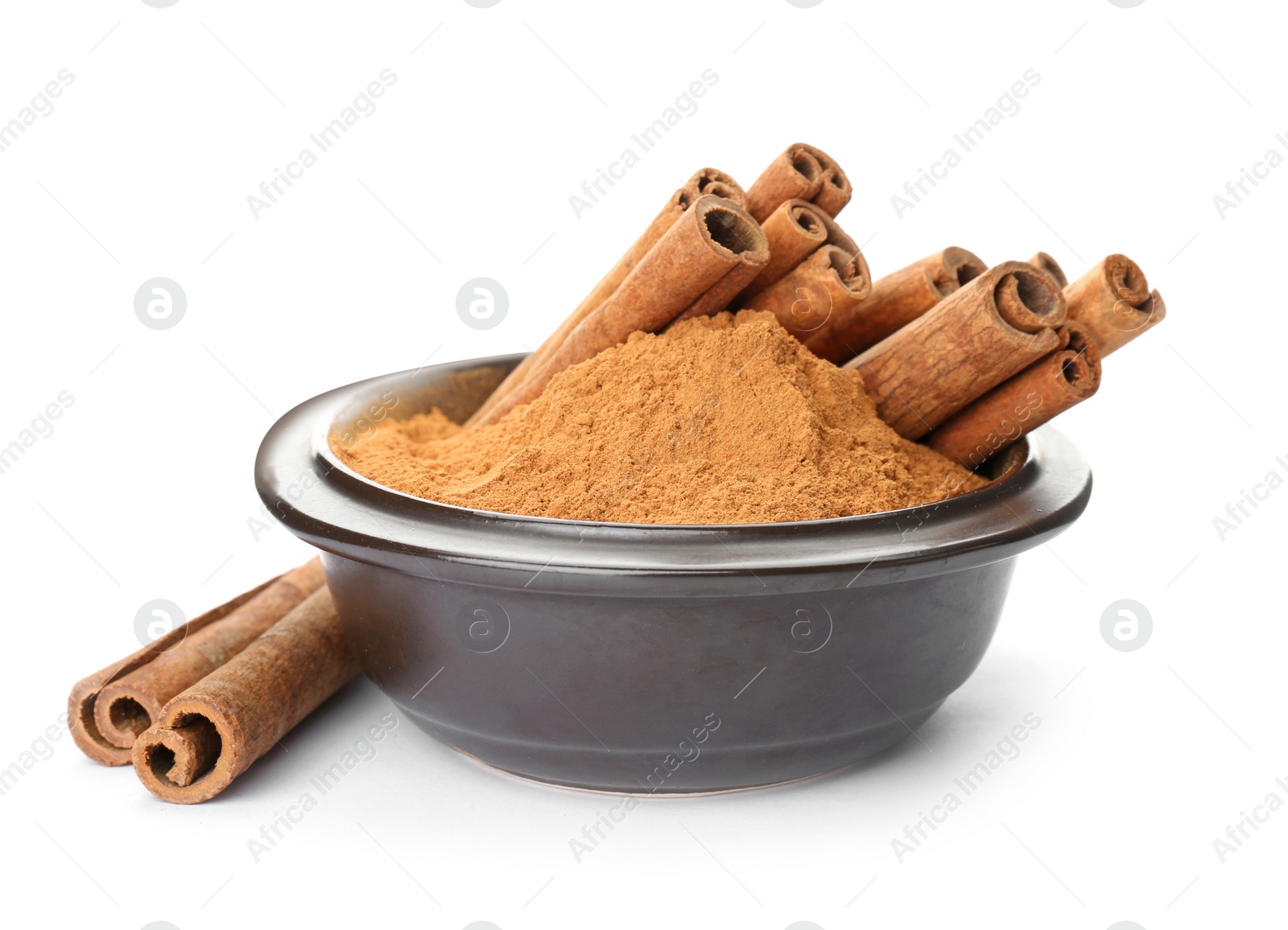 Photo of Bowl with aromatic cinnamon sticks and powder on white background