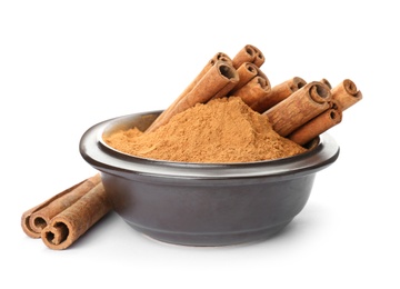 Photo of Bowl with aromatic cinnamon sticks and powder on white background