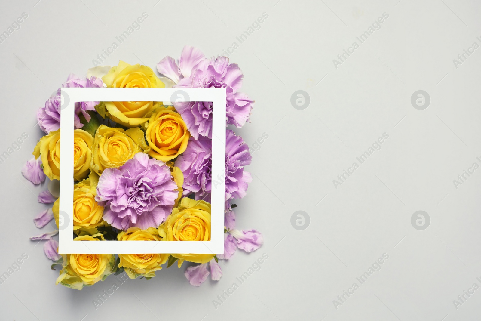 Photo of Flat lay composition with beautiful blooming flowers on grey background