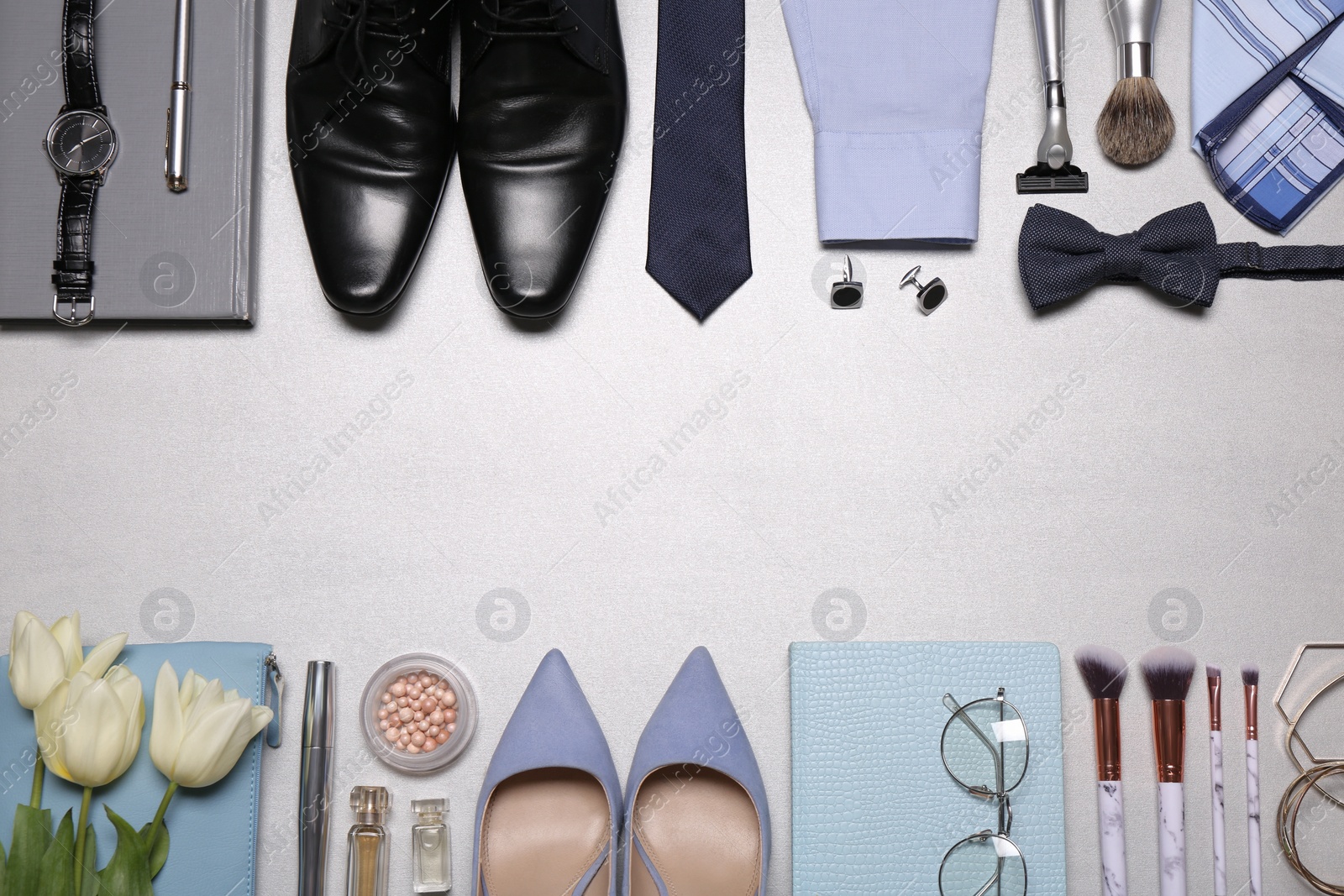 Photo of Flat lay composition with fashionable woman's and man's accessories on light background. Space for text