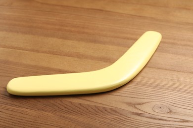 Yellow boomerang on wooden background. Outdoors activity