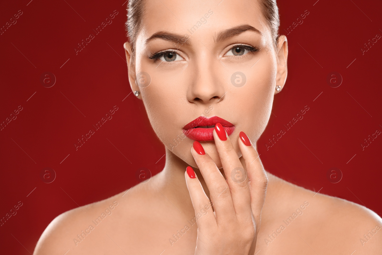 Photo of Beautiful young woman with bright manicure on color background, closeup. Nail polish trends