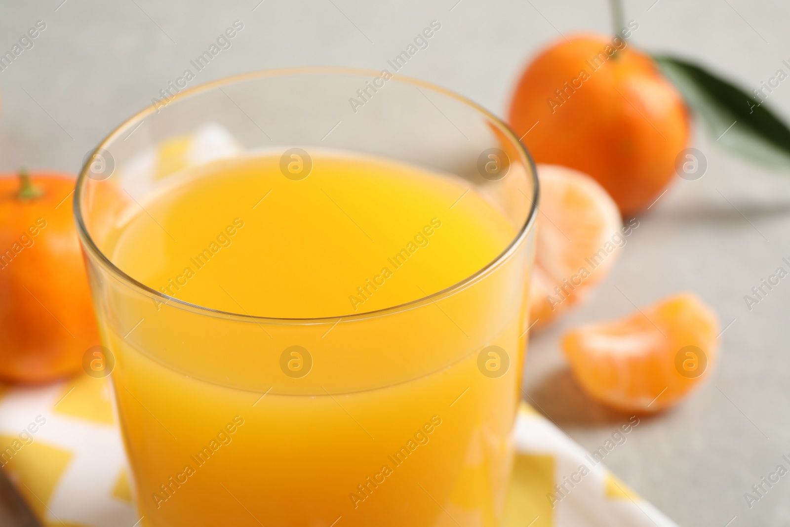 Photo of Glass of fresh tangerine juice, closeup view