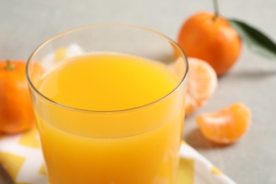 Photo of Glass of fresh tangerine juice, closeup view