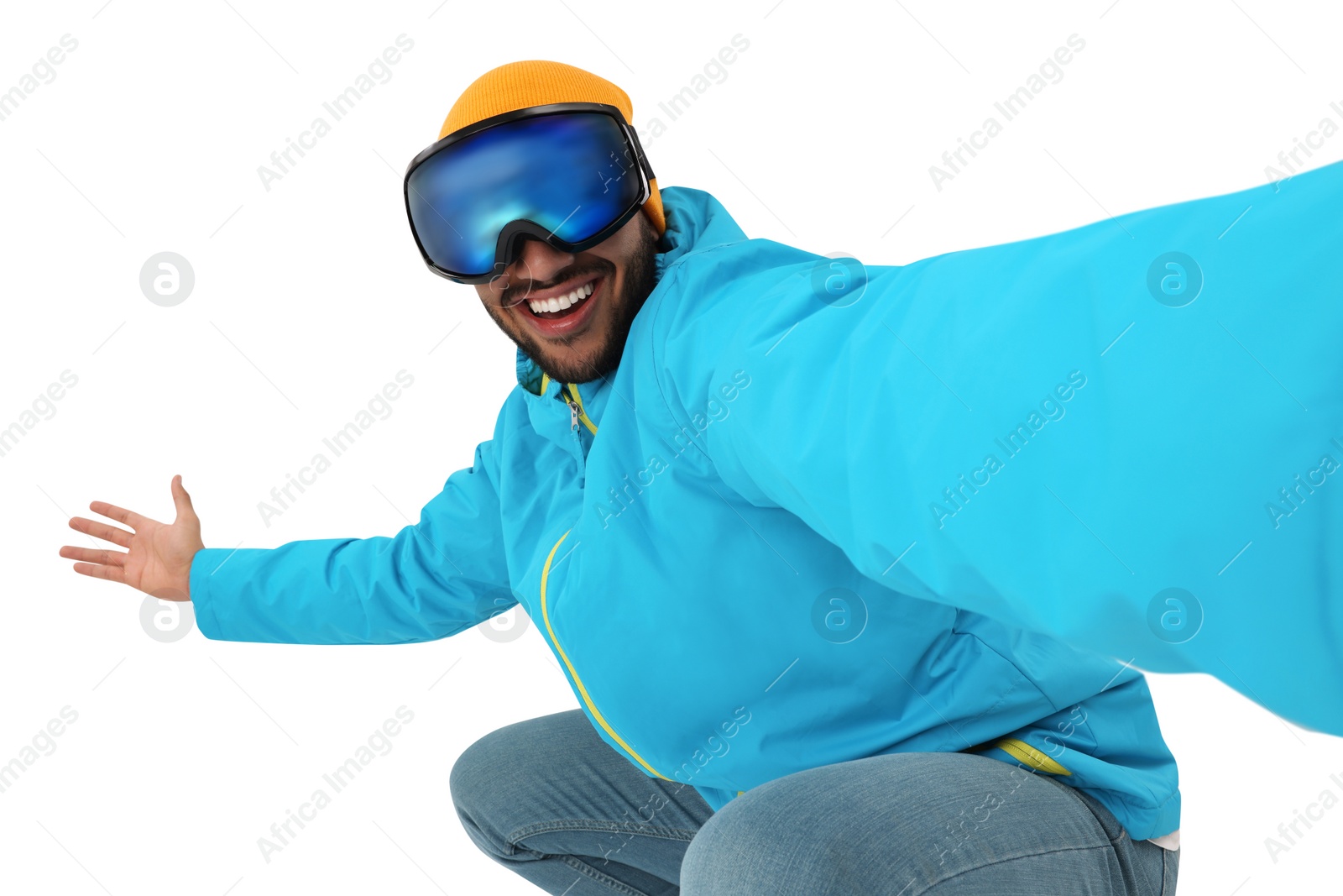 Photo of Smiling young man in ski goggles taking selfie on white background