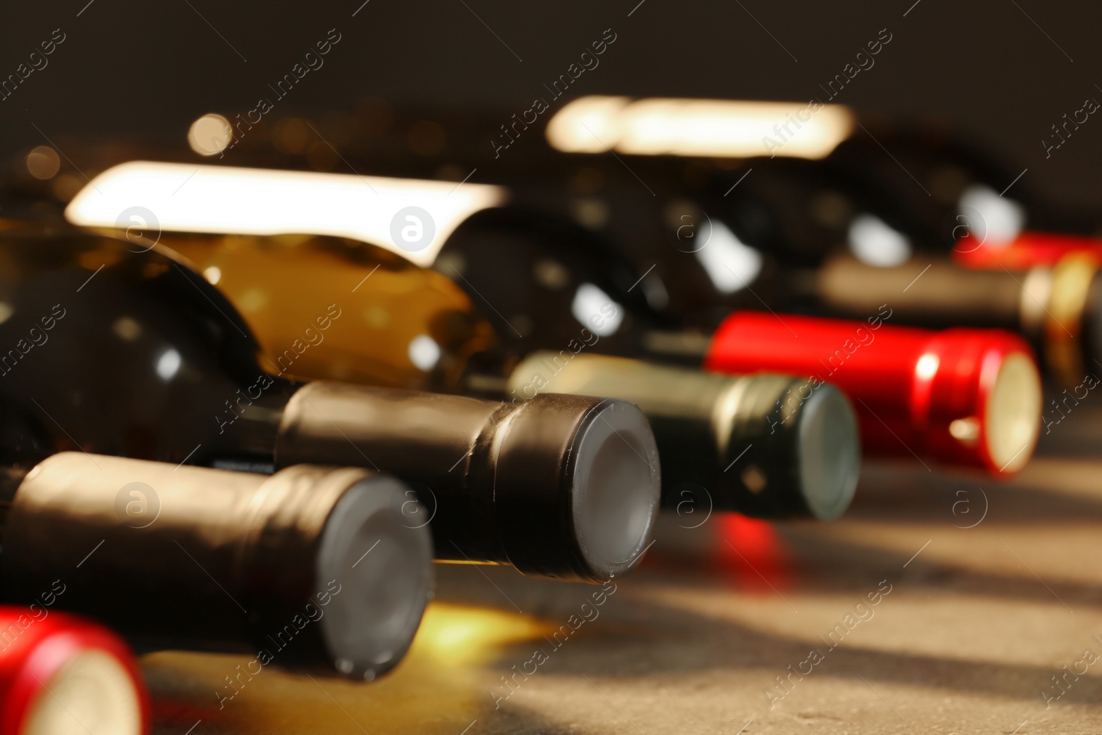 Photo of Bottles of different wines, closeup. Expensive collection