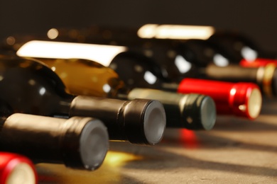 Photo of Bottles of different wines, closeup. Expensive collection