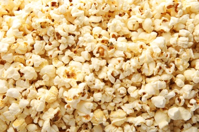 Photo of Tasty fresh popcorn as background, top view