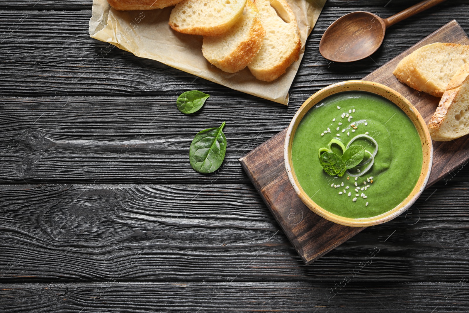 Photo of Fresh vegetable detox soup made of spinach served on table, top view. Space for text