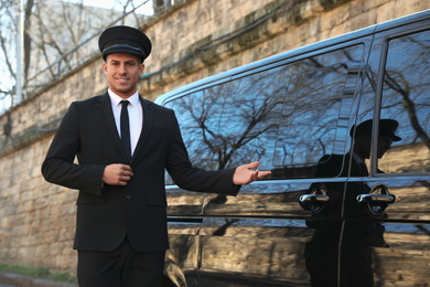 Professional driver near luxury car outdoors. Chauffeur service
