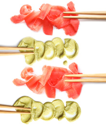 Set of delicious sauce condiments and chopsticks on white background, top view