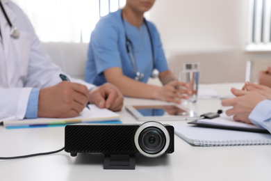 Photo of Video projector on table during medical conference