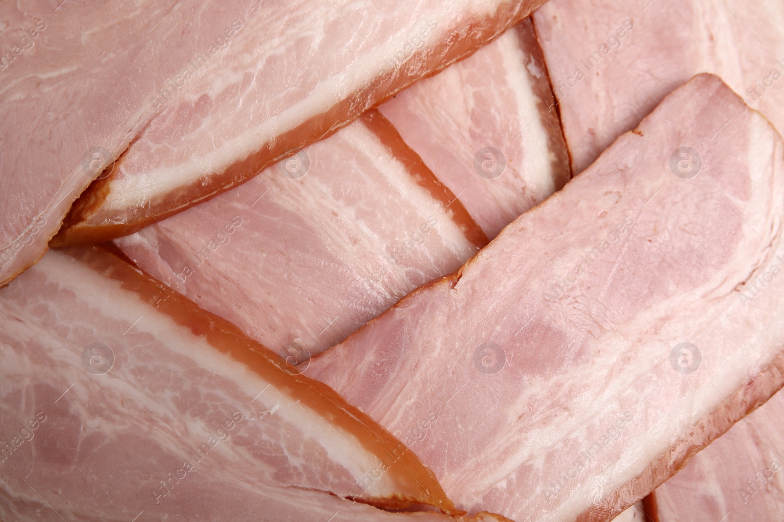 Photo of Slices of delicious smoked bacon as background, closeup