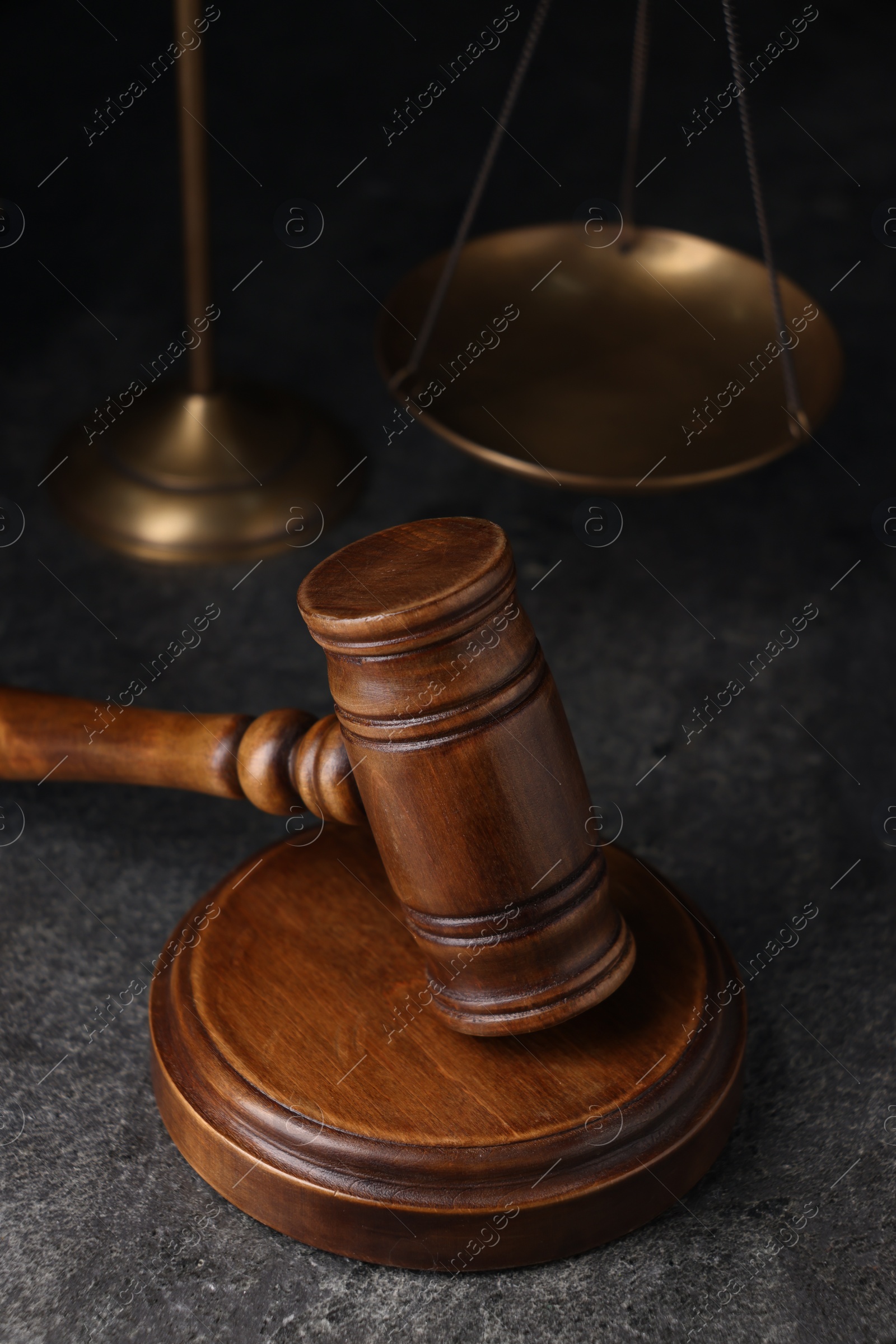 Photo of Law concept. Judge's wooden gavel on grey textured table