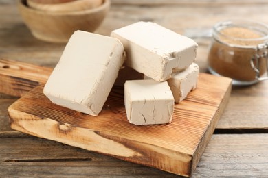 Blocks of compressed yeast on wooden table