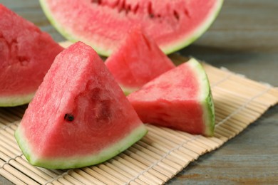 Photo of Slices of tasty ripe watermelon on wooden table, closeup