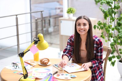 Photo of Female designer working at desk in office