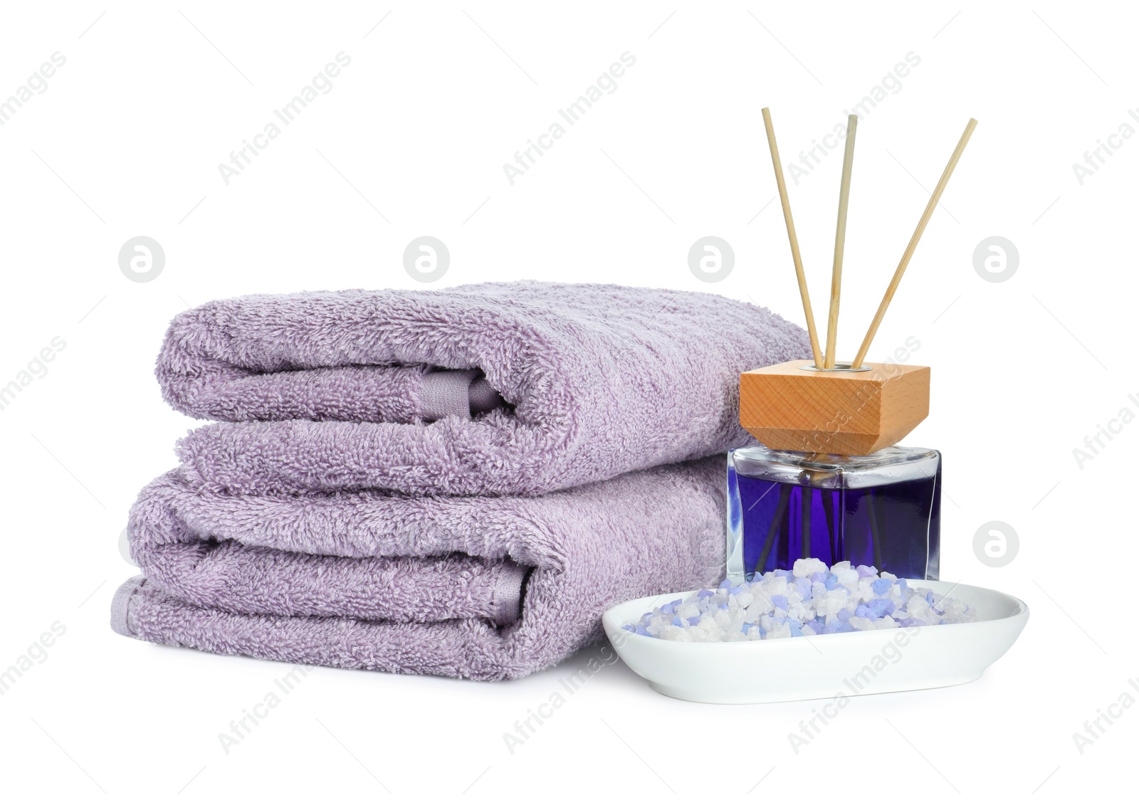 Photo of Spa composition. Towels, sea salt and reed air freshener on white background