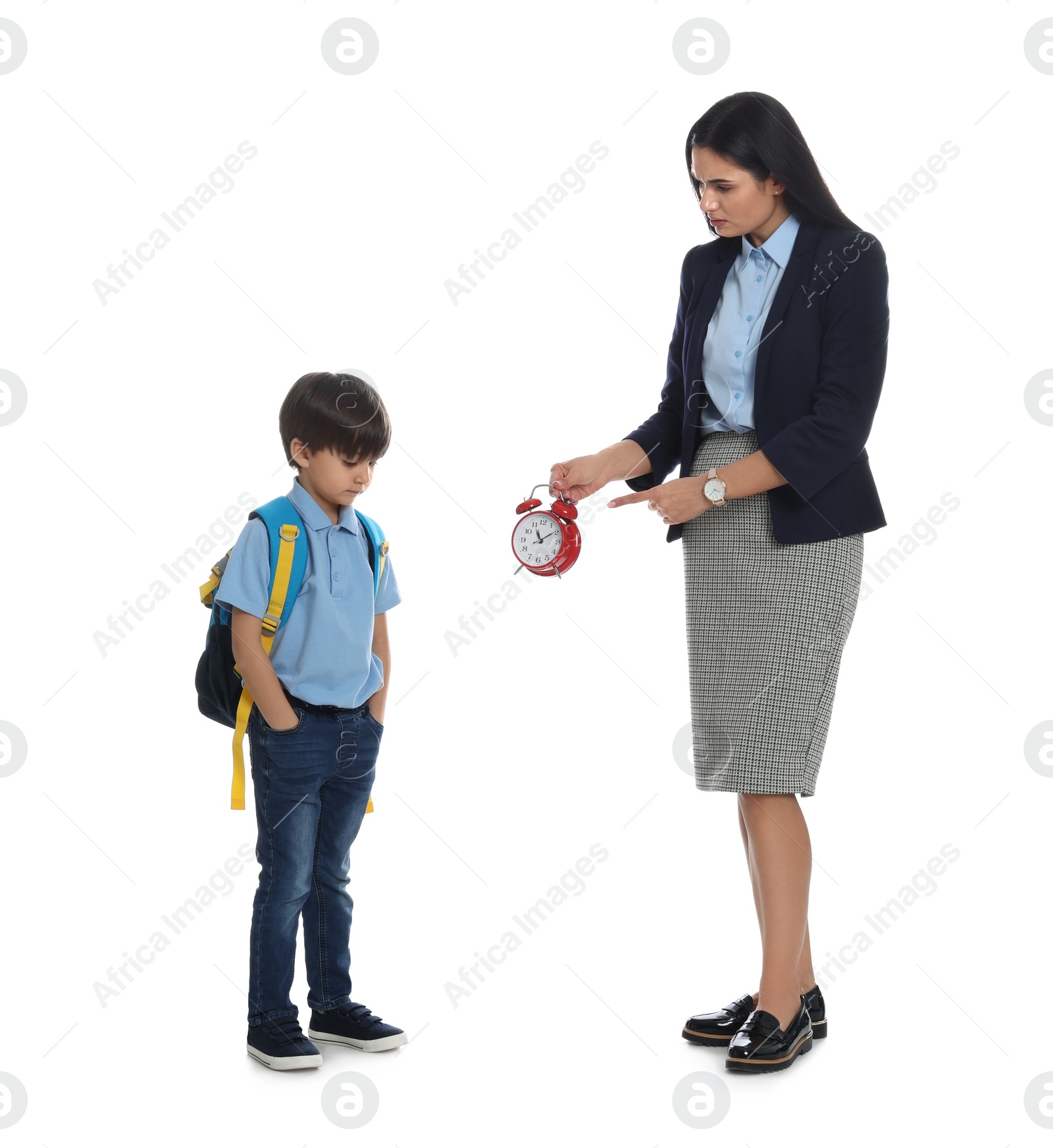 Photo of Teacher with alarm clock scolding pupil for being late against white background