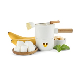 Fondue pot with chocolate and products on white background