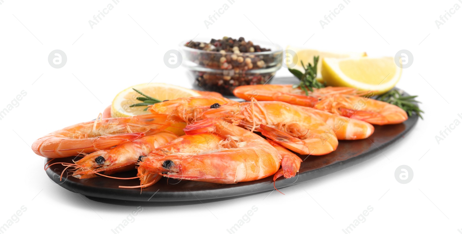 Photo of Delicious cooked shrimps served with lemon, pepper and rosemary on white background