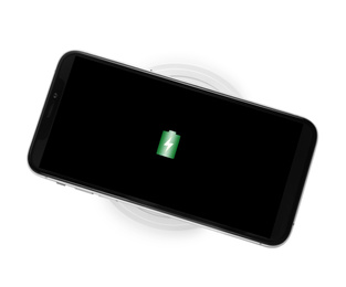Photo of Mobile phone charging with wireless pad isolated on white, top view