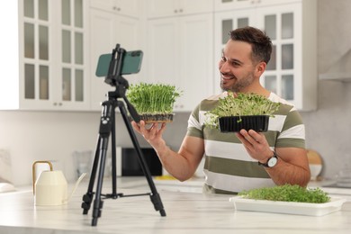 Teacher with microgreens conducting online course in kitchen. Time for hobby