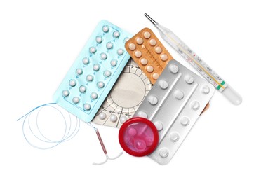 Photo of Contraceptive pills, condom and intrauterine device isolated on white, top view. Different birth control methods