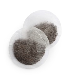 New round tea bags on white background, top view