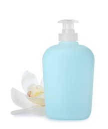 Photo of Dispenser of liquid soap and orchid flower on white background