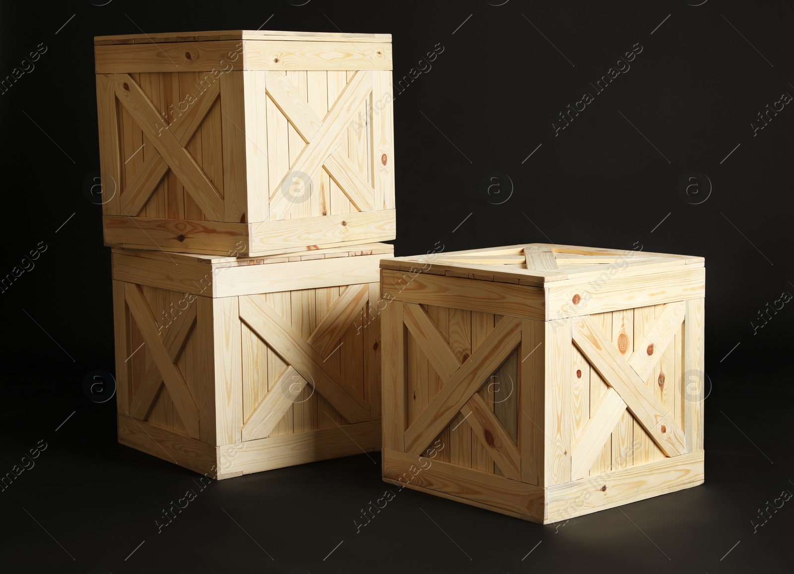 Photo of Group of wooden crates on black background