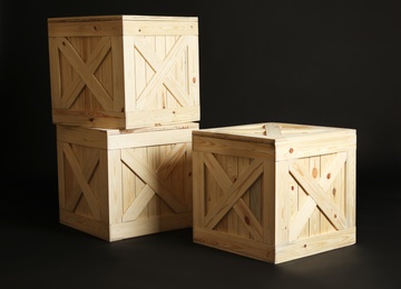 Photo of Group of wooden crates on black background