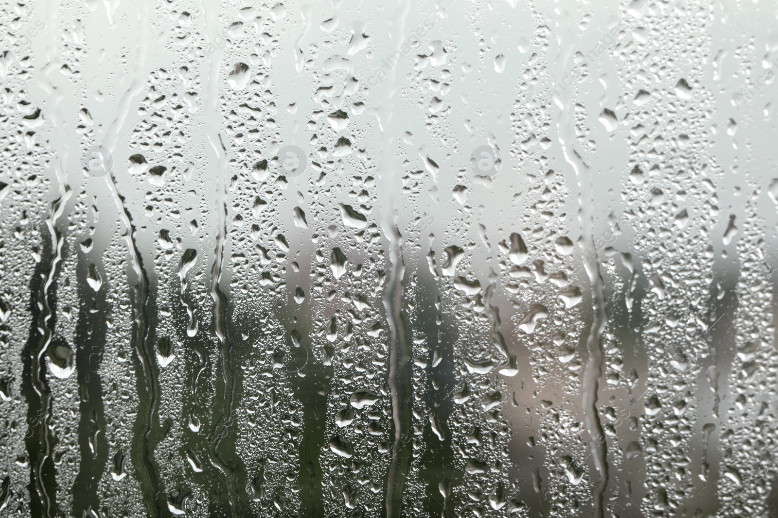 Photo of Window glass with raindrops as background, closeup