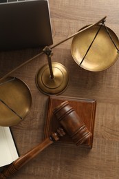 Photo of Law concept. Gavel and scales of justice on wooden table, flat lay
