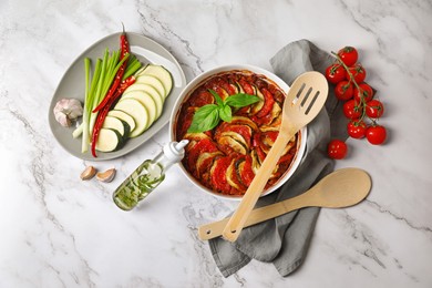 Delicious ratatouille and ingredients on white marble table, flat lay