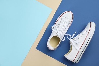 Photo of Stylish sneakers on color background, flat lay. Space for text